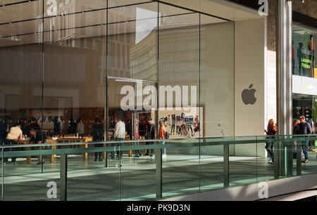 People inside browsing the products at the Apple store in Liverpool One shopping complex. Stock Photo