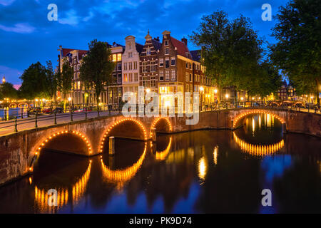 Amterdam canal, bridge and medieval houses in the evening Stock Photo