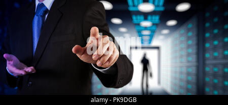 Businessman working with VR wide blank screen computer on server room in background. Stock Photo
