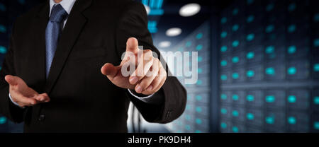 Businessman working with VR wide blank screen computer on server room in background. Stock Photo