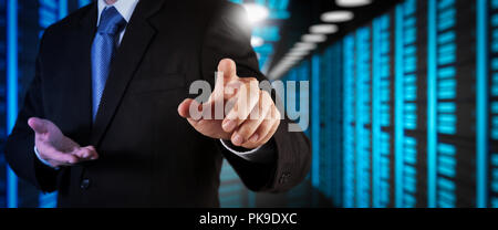 Businessman working with VR wide blank screen computer on server room in background. Stock Photo