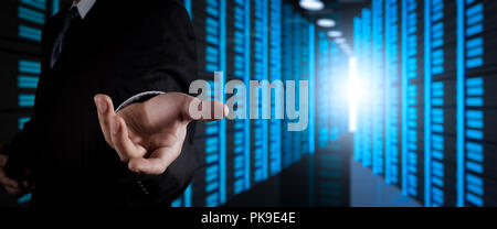 Businessman working with VR wide blank screen computer on server room in background. Stock Photo