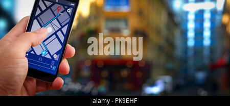 Close up of Tourist using GPS map navigation on smartphone application screen for direction to destination address in the city with travel Stock Photo