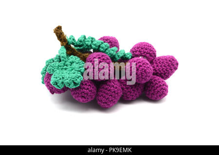 crochet red purple wine grape on isolated background. tinker in autumn. Stock Photo