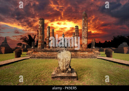 The surrounding scenery and giant statue of  Buddha and beautiful sky in Wat Mahathat at Sukhothai Historical Park, Thailand Stock Photo