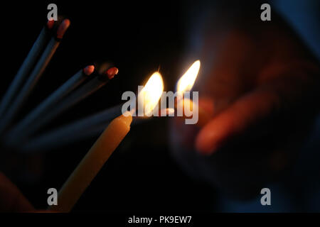 Buddhists make merit, Placing the lit incense with lamp frame for worship Buddha. Selective focus. Stock Photo