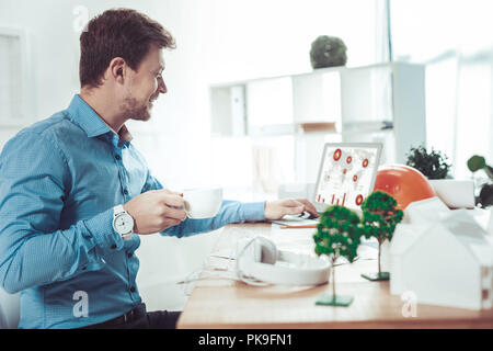 Profile photo of handsome brunette that using laptop Stock Photo