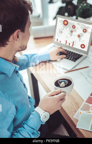 Close up of serious man that analyzing diagram Stock Photo