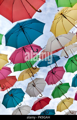 Collection of colorful umbrellas hooked in the street Stock Photo