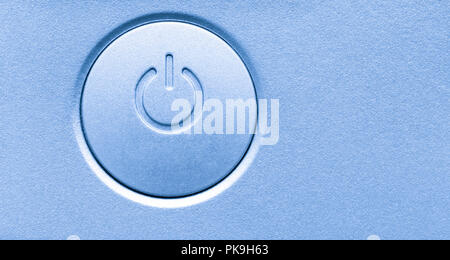 Close up of computer electronic device on/off power button. Horizontal background image with empty blank copy space. Modern technology symbol icon. Stock Photo
