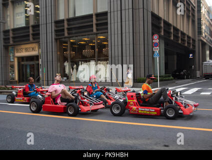 People driving karting cars dressed in super Mario, Kanto region, Tokyo, Japan Stock Photo