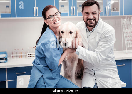 Positive delighted vet workers posing on camera Stock Photo