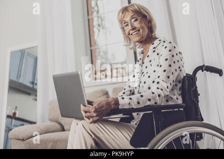 Elderly woman watching movie sitting in wheelchair Stock Photo