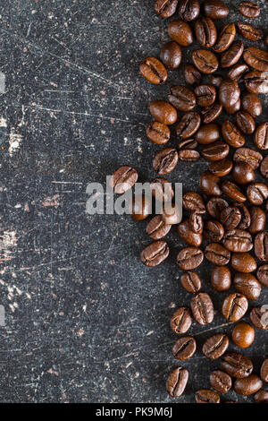 Roasted coffee beans on old kitchen table. Stock Photo
