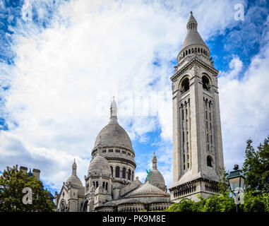 sacre-coeur limestone Cathedral montmarte , paris,france during sunnyday with green conopy and bright blue sky and white cloud Stock Photo