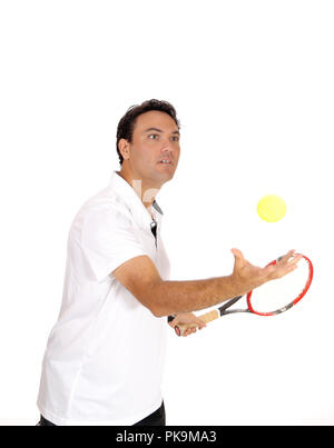 A handsome young man in a white shirt trothing his yellow ball in the catching it with his hand, isolated for white background Stock Photo