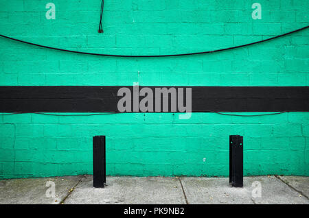 Green painted brick wall with black stripe, abstract urban background, New York City. Stock Photo
