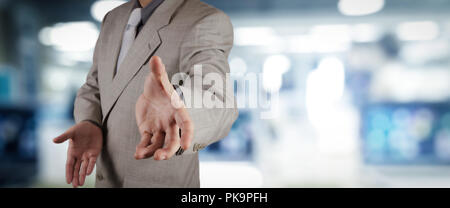 businessman workimg on VR blank wide touch screen computer on office blur background. Stock Photo