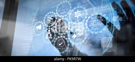 Project management diagram of cost, time, scope, human resources, risks, quality and communication with icons.Businessman working with wide screen com Stock Photo