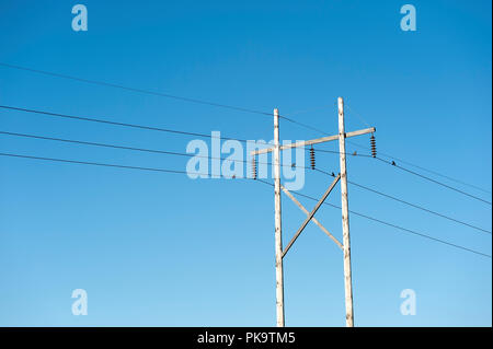 hydro wires on double wooden poles Stock Photo