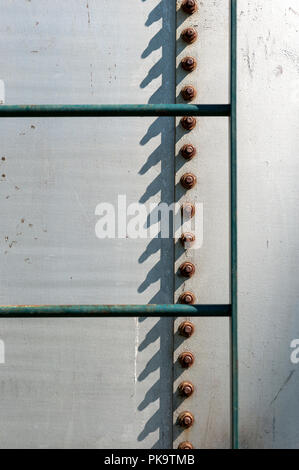 rusting metal bolts/screws on a silo Stock Photo