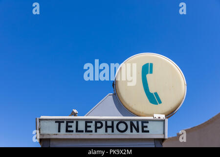Telephone sign on phone booth; California, USA Stock Photo