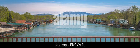 Small wooden houses and restaurants on the riverbank  of the Ada Bojana river near Ulcinj, Montenegro Stock Photo