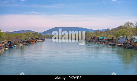 Small wooden houses and restaurants on the riverbank  of the Ada Bojana river near Ulcinj, Montenegro Stock Photo