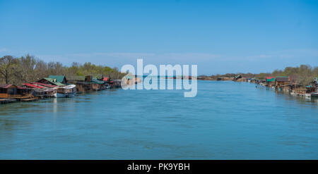 Small wooden houses and restaurants on the riverbank  of the Ada Bojana river near Ulcinj, Montenegro Stock Photo