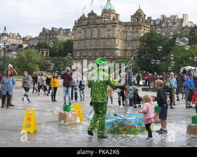 The Edinburgh Festival may be over, but the fun continues with street entertainment for the crowds on Princes Street from Bubble Man's giant bubbles. Stock Photo