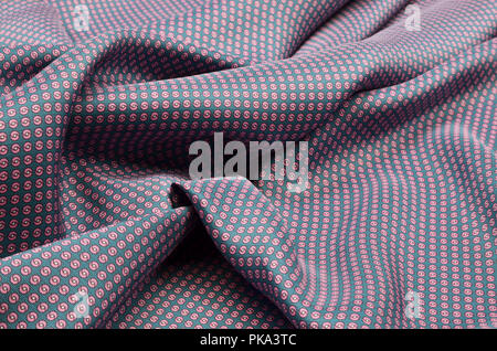 Silk fabric, pink polka dots on turquoise Stock Photo