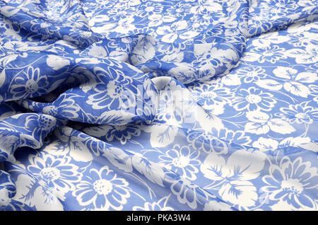 Silk fabric, chiffon in a large floral ornament on a blue Stock Photo