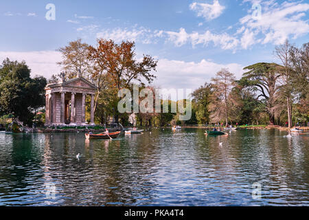 Italy, Rome, April 8/ 2018, Villa Borghese, Temple of Esculapio, Pincian Hill, people on boats in the lake Stock Photo
