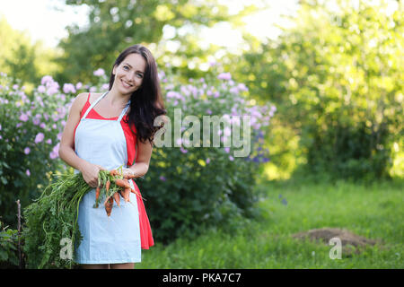 Girl with a harvest of vegetables in the garden  Stock Photo