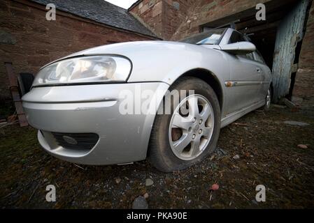 Popped tyre on a car (broken down vauxhall with a deflated tyre from a puncture) Stock Photo