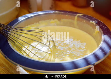 Mixing butter and sugar in bowl with mixing machine, making bakery Stock Photo