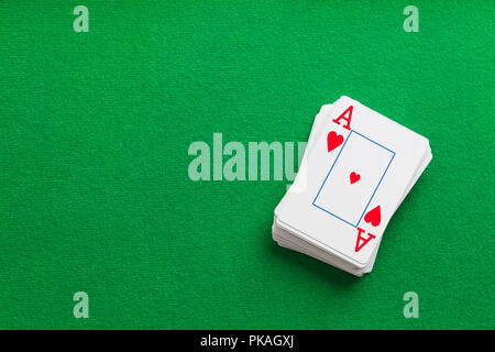 Deck of Playing Cards on Green Table With Copy Space. Stock Photo