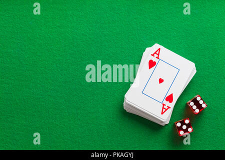 Deck of Playing Cards and Dice on Green Table. Stock Photo