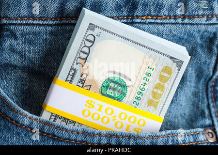 Stack of Cash Stuffed in Blue Jeans. Stock Photo
