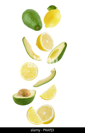 Isolated flying fruits. Falling fresh lemon and avocado isolated on white background with clipping path as package design element and advertising. Stock Photo