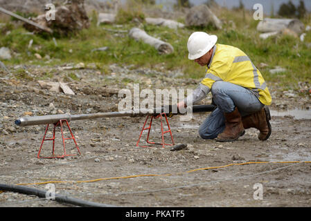 MOANA, NEW ZEALAND, OCTOBER 27, 2017: An unidentified engineer prepares a a recording tool for logging an abandoned oil well in preparation for cappin Stock Photo
