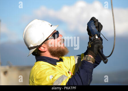 MOANA, NEW ZEALAND, OCTOBER 27, 2017: An unidentified engineer checks the guage during a pressure test on an abandoned oil well in preparation for cap Stock Photo