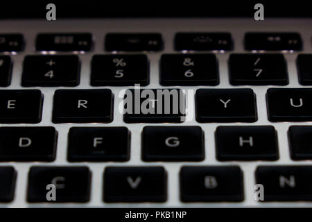 Detail illuminating the keyboard with a focus on Capslock. Stock Photo
