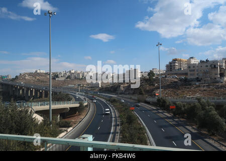 View of residential houses of Beit Hanina a Palestinian neighborhood with highway 60 or Route 60 connecting Pisgat Ze'ev or Pisgat Zeev an Israeli settlement in East Jerusalem one of the city's five Ring Neighborhoods on land annexed after 1967 war in Israel Stock Photo