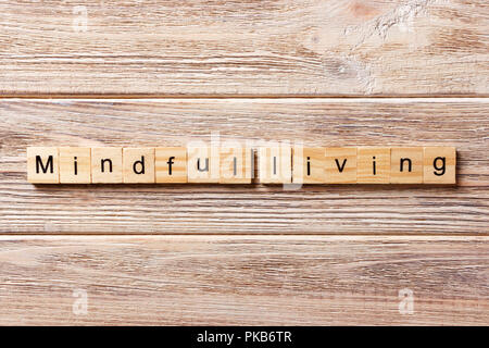 mindful living word written on wood block. mindful living text on table, concept. Stock Photo