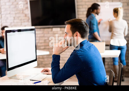 Young architect working on computer in office Stock Photo