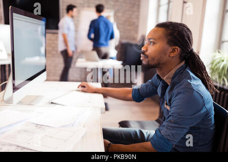 Young architect working on computer in office Stock Photo