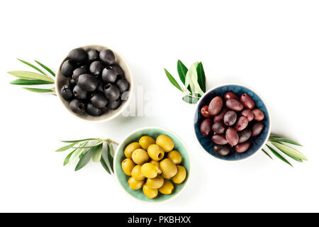 Overhead photo of various olives in bowls on white with copy space Stock Photo