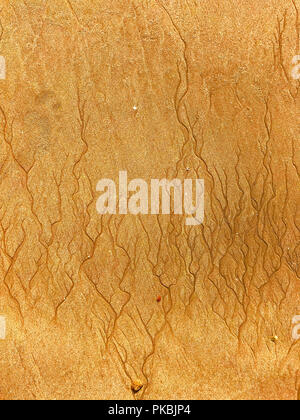 Beautiful thin traces of water on the yellow sand Stock Photo