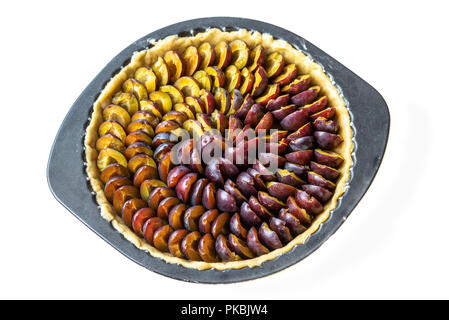 Pie with Alsace quetsches before cooking on white background Stock Photo